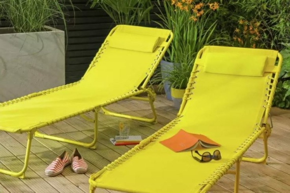 two bright yellow sun loungers made from metal and fabric