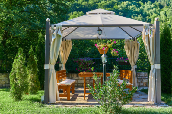 a metal-framed gazebo with luxurious canvas curtains