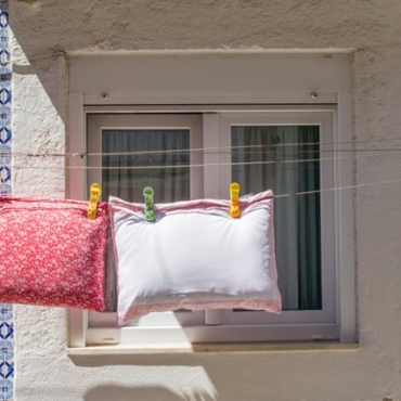 garden furniture cushions drying on a line
