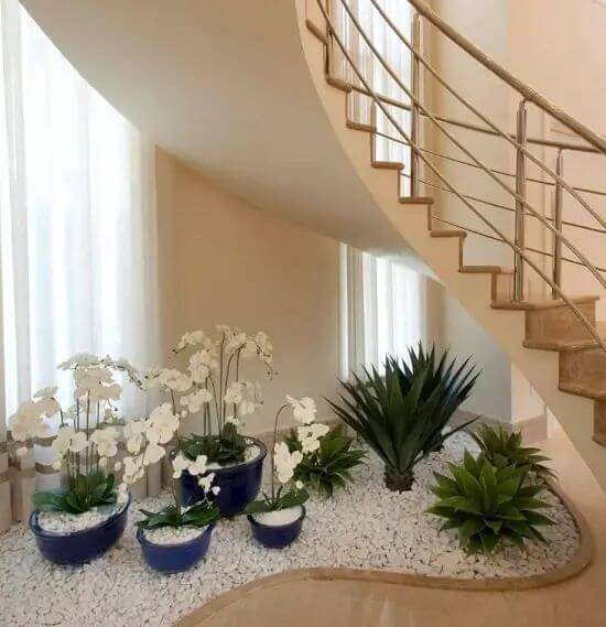 white orchids & pebbles under the staircase